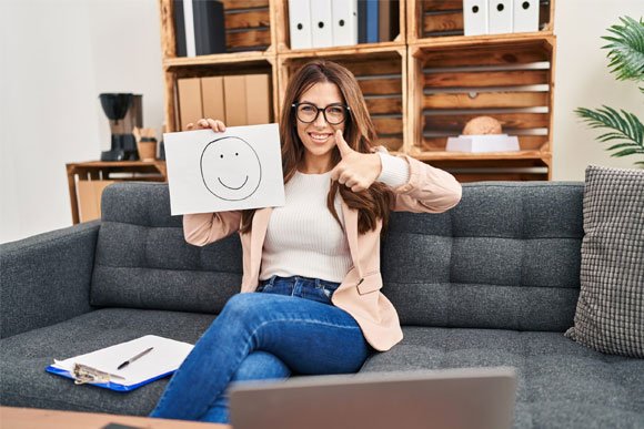 adhd provider on couch giving a thumbs up